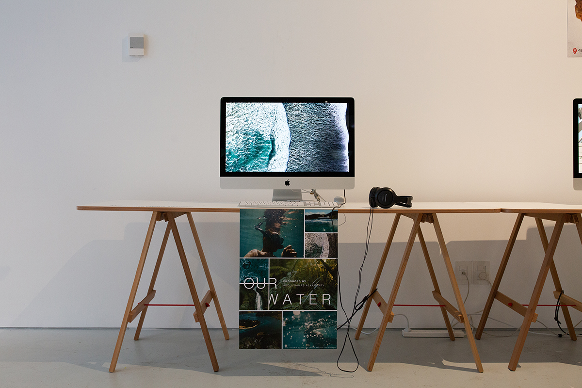 Computer with a looped video and poster 